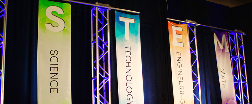 Hanging STEM banners at conference.