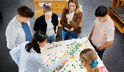 A group of people surrounding city layout map.