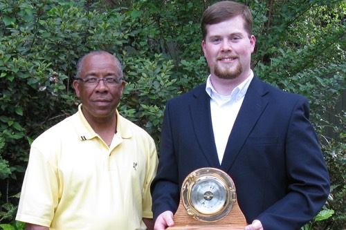 Richard Benjamin (left) of ExxonMobil presents the ExxonMobil Academic Award to Chris Morris, the 2008 outstanding senior in meteorology.