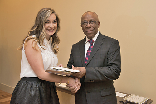 Shelby Graham receives the award from Richard Benjamin of ExxonMobil..