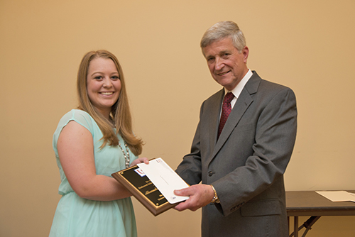 Alexandra Kabeiseman is congratulated by Dr. Bill Williams.