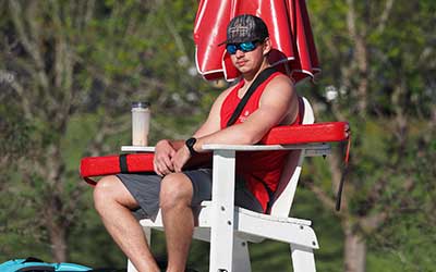 Lifeguard at outdoor pool.