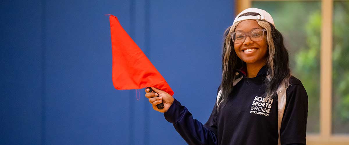 Student holding an orange flag.