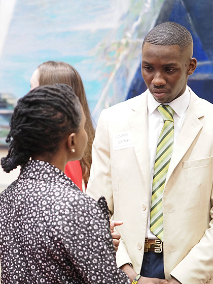 Student speaking with employer ar career fair event.