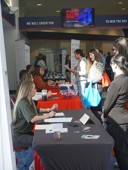 Students talking to employers at career fair.