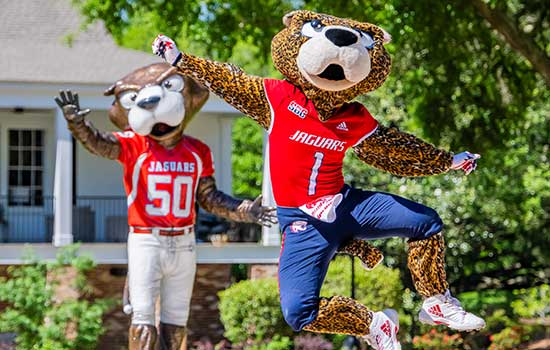 Southpaw kicking up his heels in front of Southpaw statue.