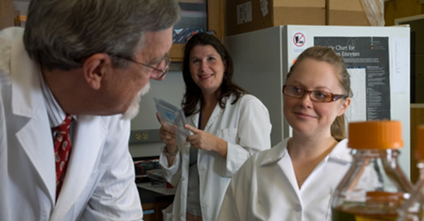 Professors and students working in lab.