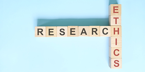 Scrabble pieces spelling out Research Ethics.