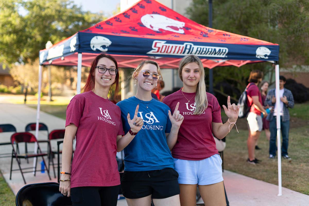 USA housing tent tailgate with students holding 'J'&nbsp;